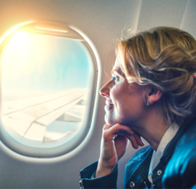 Unused ticket management - woman looking out window of aeroplane