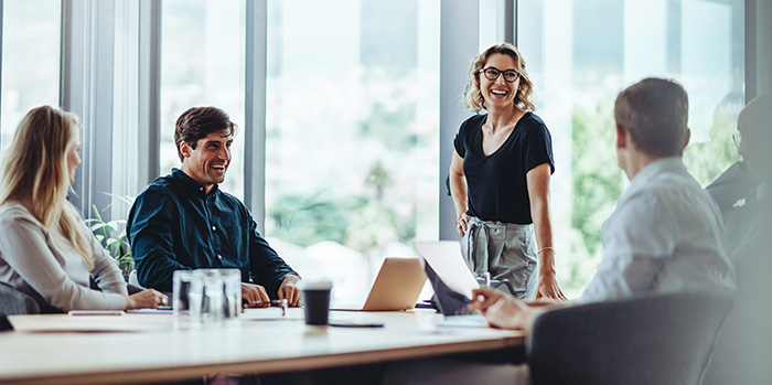 Businesspeople in a meeting room discussing airline contract negotiation & management